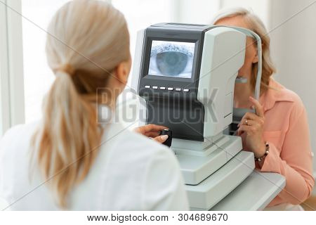 Focused Ophthalmologist Using Computer Technologies While Screening