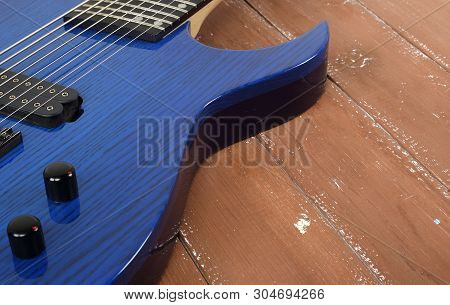 Musical Instrument - Fragment 8-string Blue Electric Guitar Solid-body On A Wood Background