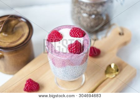 Chia Seed Parfait Pudding With Almond Milk, Yogurt, Pink Pitaya Dragon Fruit Powder And Raspberries 