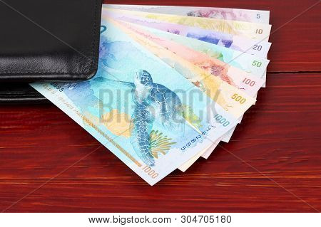 Maldivian Rufiyaa In The Black Wallet On A Wooden Background