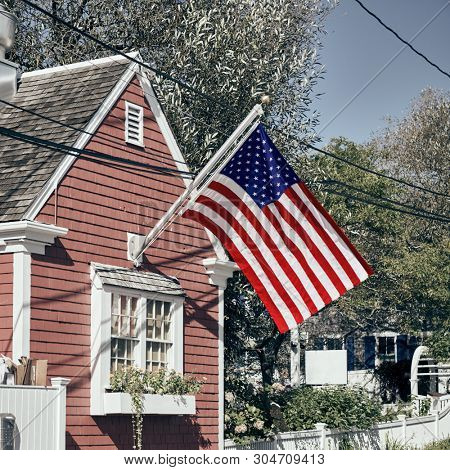 United States flag at suburban neighborhood. Provincetown, Cape Cod, Massachusetts, USA. 
