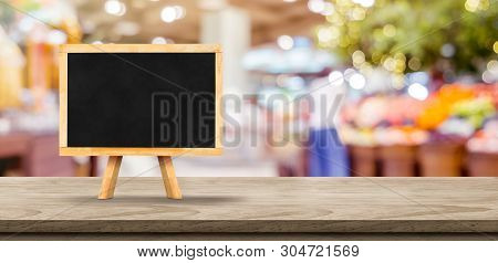 Blank Blackborad On Wooden Table Top With Blur People Shopping At Supermarket Bokeh Background,mock 