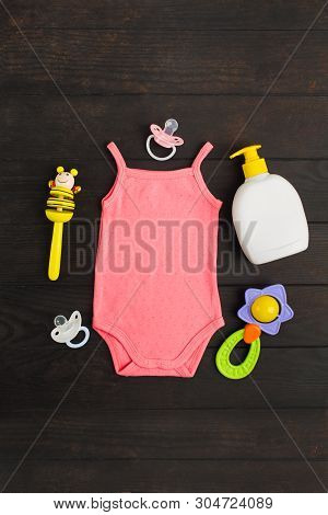 Baby Shower Accessories. Pink Summer Bodysuit, Two Sylicone Pacifiers And Two Wooden And Plastic Rat