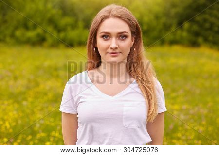 Close Up Portrait Of Beautiful Young Caucasian Woman Resting In Nature, Poses Isolated Over Meadow B
