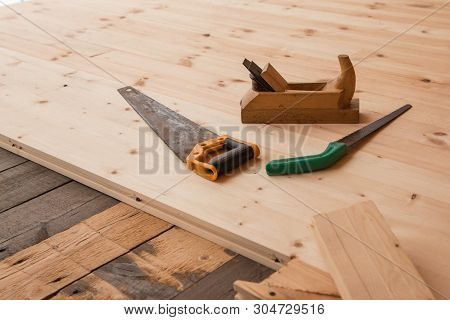 Jointer And Saw. Old Wooden Jointer Carpenter Tool And Metal Saw On Wooden Background