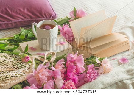 Still Life Details In Home Interior Of Living Room. Cup Of Tea With Pions Flowers And Spring Decor O