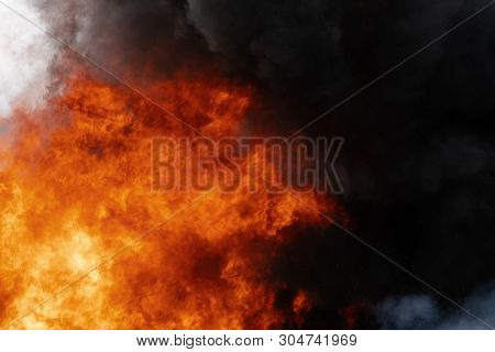 Dangerous Flames Of Red-orange Fire, Motion Clouds Of Black Smoke Covered Sky. Defocus, Motion Blur,