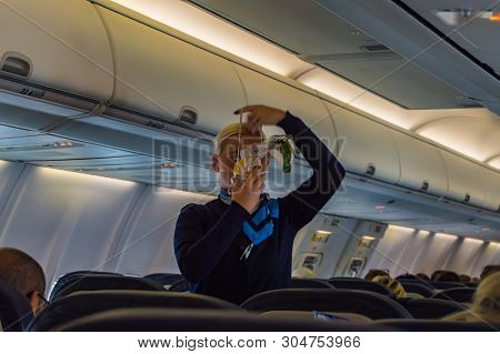 Palma - Spain 18 Avril 2019: Air Hostess Shows How To Use An Oxygen Mask On Board.
