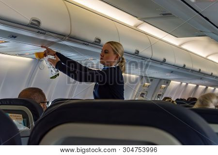Palma - Spain 18 Avril 2019: Air Hostess Shows How To Use An Oxygen Mask On Board.