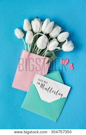 Floral Flat Lay For Mother's Day Celebration With Tulips And Greeting Card In German