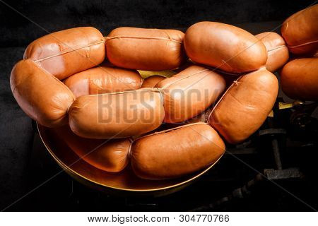 Closeup Bunch Of Short Thick Wieners Rolled In Spiral On Scales