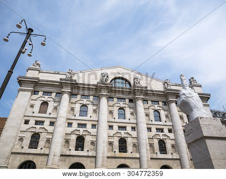 Milan, Italy - May 25, 2019: Mezzanotte Palace Facade And Middle Finger Sculpture In Milan Stock Exc