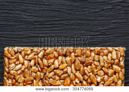 Tile Kozinaki From Sunflower Seeds On A Black Textural Background. Delicious Oriental Sweets Gozinak