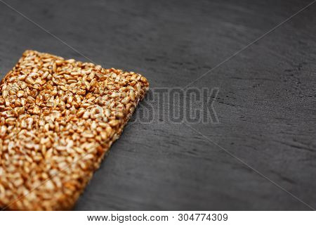 Tile Kozinaki From Sunflower Seeds On A Black Textural Background. Delicious Oriental Sweets Gozinak