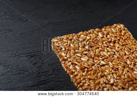Tile Kozinaki From Sunflower Seeds On A Black Textural Background. Delicious Oriental Sweets Gozinak