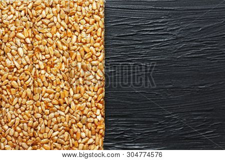 Tile Kozinaki From Sunflower Seeds On A Black Textural Background. Delicious Oriental Sweets Gozinak