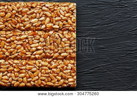Tile Kozinaki From Sunflower Seeds On A Black Textural Background. Delicious Oriental Sweets Gozinak