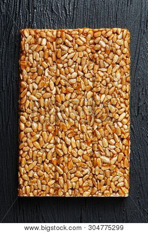 Tile Kozinaki From Sunflower Seeds On A Black Textural Background. Delicious Oriental Sweets Gozinak