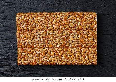 Tile Kozinaki From Sunflower Seeds On A Black Textural Background. Delicious Oriental Sweets Gozinak
