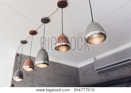 Modern Chandelier With Led Lamps Hanging On The Ceiling In The Interior Of The Room Inside The House