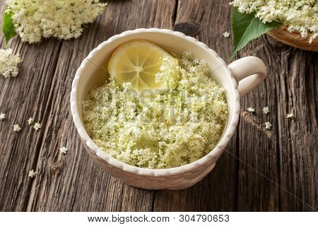 Elder Flowers And Lemon Macerating In Water - Preparation Of Homemade Syrup