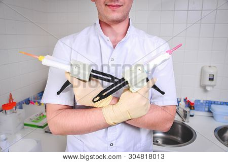 Bryansk, Russia. 18.03.2019: The Dentist Applies The Gel To The Surface Of The Patient’s Teeth. Prof