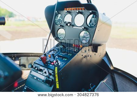 Black Control Panel In A Helicopter Cockpit.