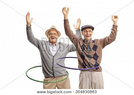Two cheerful senior men spininng hula hoops isolated on white background
