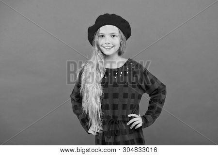 Wear Beret Like Fashion Girl. Kid Little Cute Girl With Long Blonde Hair Posing In Beret Hat And Che