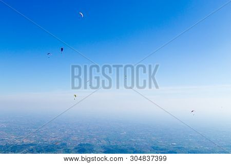 Paraglider On Blue Sky. Borso Del Grappa, Famous Paragliding Site, Italy