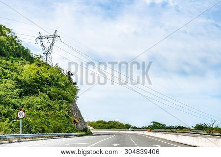 80 Km/h Speed Limit And Falling Mountain Rocks/rock Slide Street Traffic Sign With Hdvc Lines Overhe