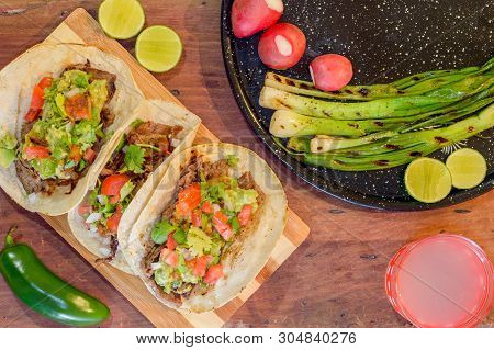Tijuana Tacos, Grilled Carne Asada With Radishes, Limes, Spring Onions, Lemonade And Condiments.