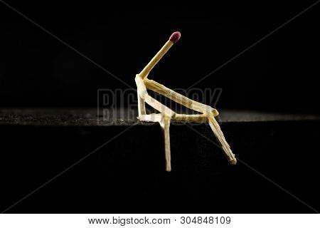 Concept Of Solitude Or Contemplation, Social Isolation. Picture Of A Man Holding Matchpost Sitting I