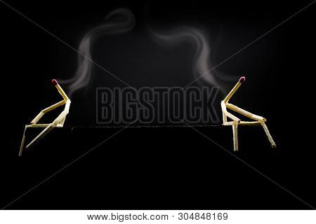 Two Characters Made Of Matchsticks Sad And Sitting In The Dark, One Away From The Other. Concept Of