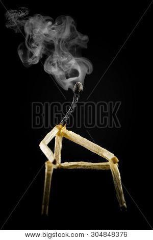 Image Of A Man Made Of Matchstick. Small And Depressive In The Dark, Erased And Losing The Flame. Co