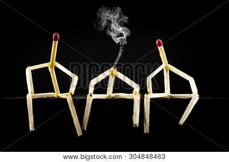 Image Of Three Men With Matchsticks Sitting In The Dark, One Of Them Sad And Erased. Concept Of Lone
