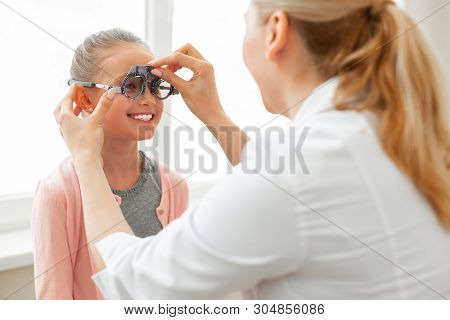 Cheerful Diligent Young Girl Showing Her Wide Smile While Motionlessly Sitting