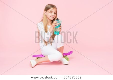 Healthy And Alive. Small Girl Skater Keeping Hydrated With Healthy Habits. Active Little Child Drink