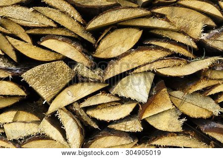 Logs Of Firewood Piled Under The Roof Of Slate. Fuel For Stove Heating. Country Life. Wooden Firewoo