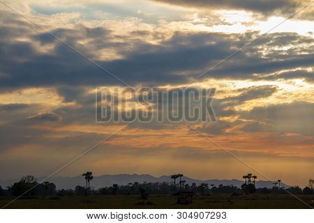 Evening Weather In The Field, Golden Cloud And Sky With Sun Light Are Shone Through The Clouds Look