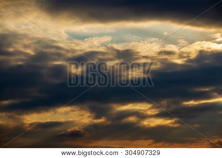 Evening Weather, Golden Cloud And Gray Sky With Sun Light Are Shone Through The Clouds Look Feel Goo