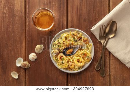 Seafood Pasta. Tagliolini With Mussels, Shrimps, Clams And Squid Rings, With A Glass Of Wine, Shells