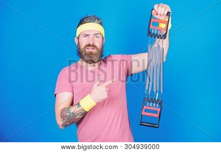 Sportsman Training Stretching Expander. Man Bearded Athlete Exercising With Expander. Guide Use Expa