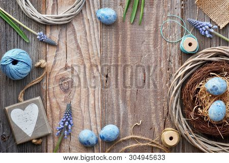 Easter Background With Blue Hyacinth Flowers, Easter Eggs, Wooden Heart And Decorations On Rustic Wo