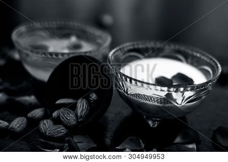Milk And Almond Face Pack On Black Colored Shiny Surface I.e. Raw Milk,almond,honey Well Mixed In A