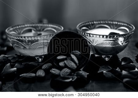 Milk And Almond Face Pack On Black Colored Shiny Surface I.e. Raw Milk,almond,honey Well Mixed In A