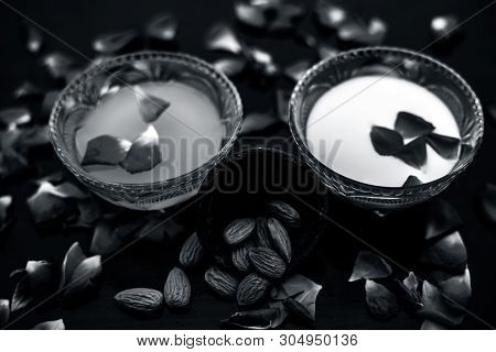 Milk And Almond Face Pack On Black Colored Shiny Surface I.e. Raw Milk,almond,honey Well Mixed In A