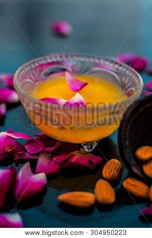 Milk And Almond Face Pack On Black Colored Shiny Surface I.e. Raw Milk,almond,honey Well Mixed In A