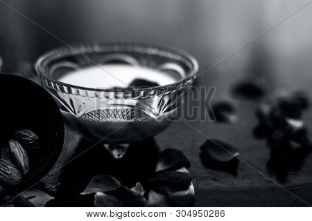Milk And Almond Face Pack On Black Colored Shiny Surface I.e. Raw Milk,almond,honey Well Mixed In A