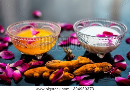 Milk Face Pack On Black Shiny Surface Consisting Of Raw Milk,turmeric Or Haldi And Badam In A Glass